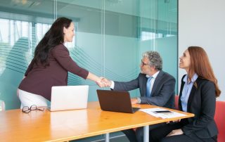 business people shaking hands in conference room