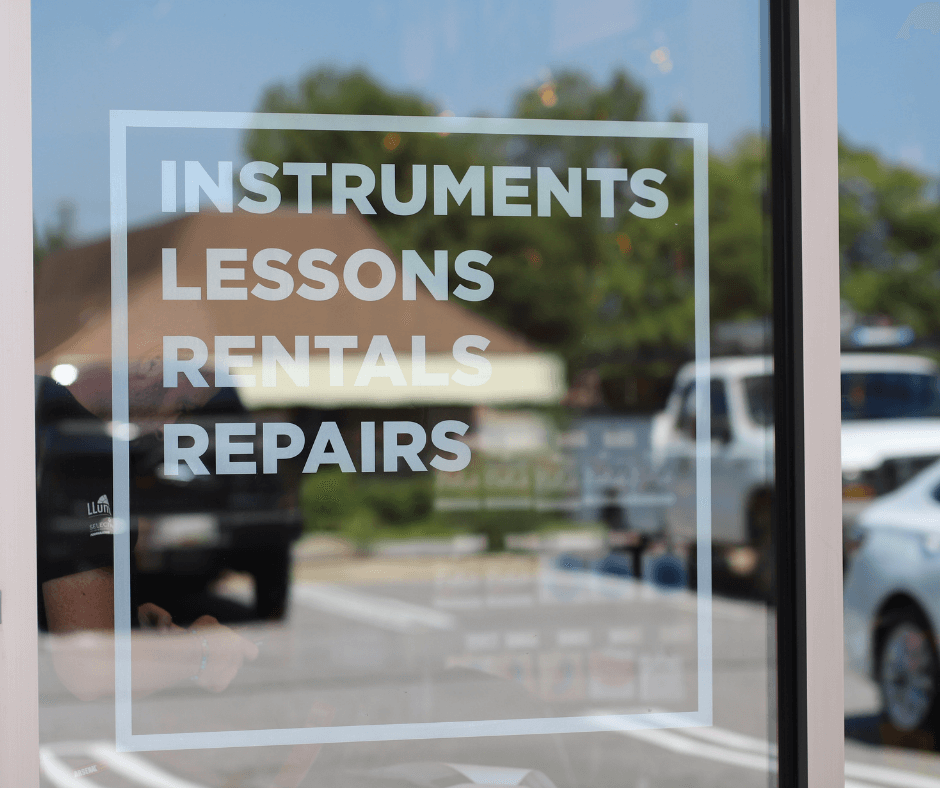instrument lessons and repairs sign storefront graphics white lettering on clear window