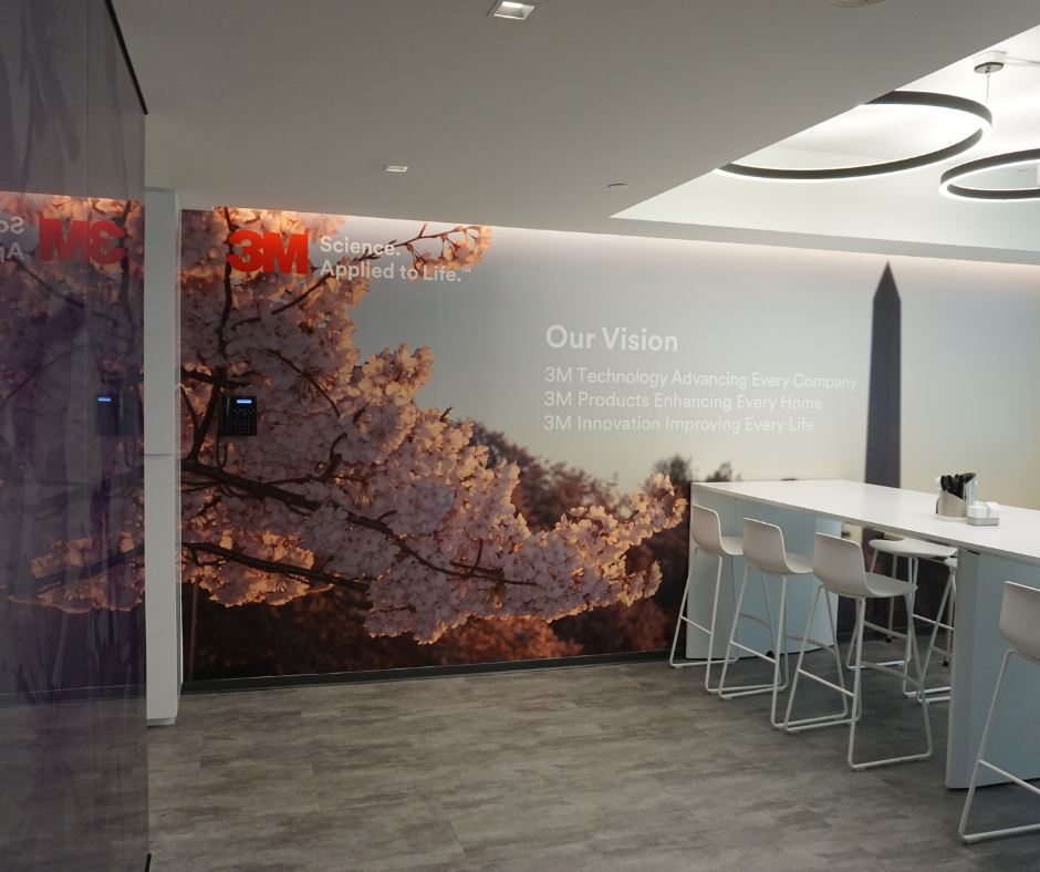 cherry blossom wall mural in break room of 3M office featuring company messaging